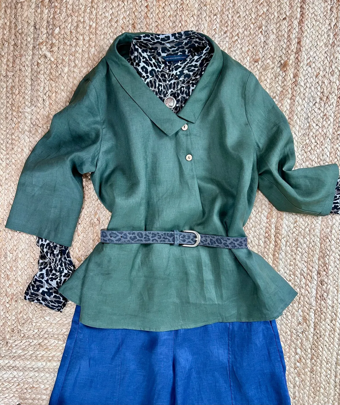 Olive tunic with animal-print top and blue trousers